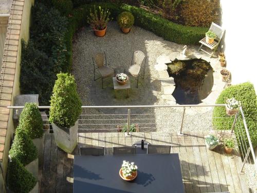 an overhead view of a patio with chairs and plants at B&B Villa Des Raisins in Bruges