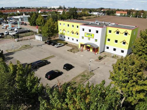 an aerial view of a parking lot with a yellow building at Hotel City Inn in Magdeburg