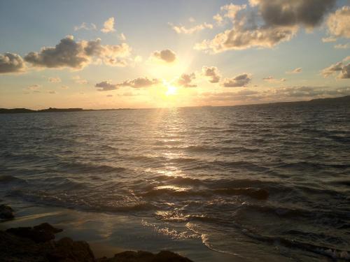 a sunset over the ocean with the sun setting at Iris Apartments in Minia