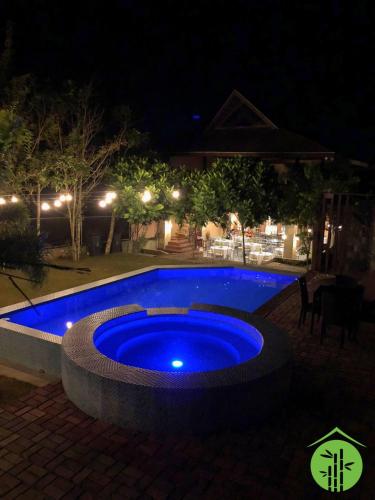 a large blue swimming pool at night at Asian Village Tagaytay in Tagaytay