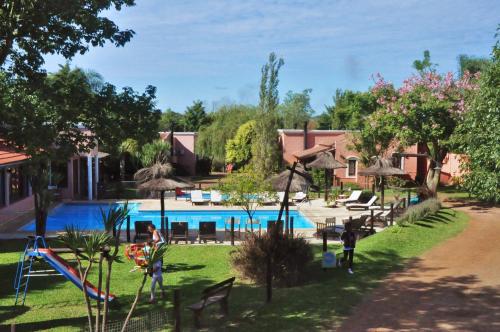 a resort with a playground and a swimming pool at Cabañas del Ysyry in Colón