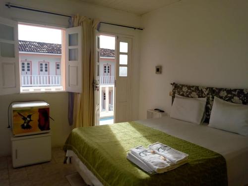 Ένα ή περισσότερα κρεβάτια σε δωμάτιο στο Pousada Asa Branca