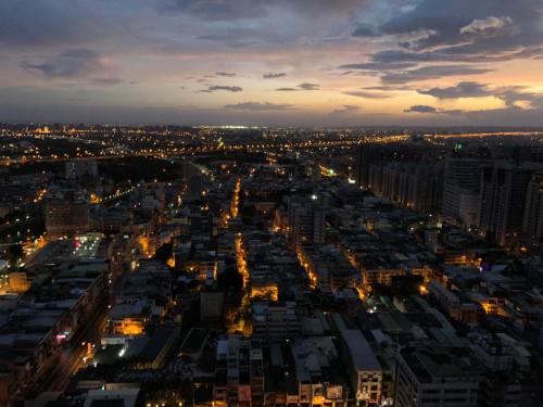 a view of a city at night with lights at XinsheHotel - Chungli in Zhongli