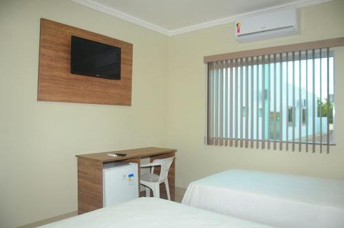En eller flere senger på et rom på Planalto Palace Hotel
