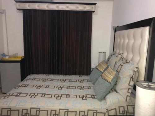 a bedroom with a large bed with a black curtain at Hotel Rey in Concepción de La Vega