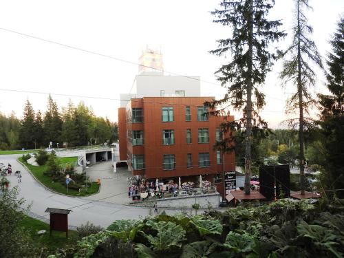 a building with a group of people outside of it at Štrbské Pleso rezidencia Oliver - apartmán 16A in Štrbské Pleso
