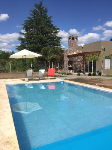 una gran piscina azul con sombrilla en El esparto en Lobos