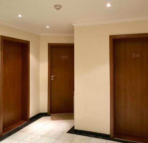 a hallway with two doors with numbers on them at Daf Trans Hotel in Peshtera