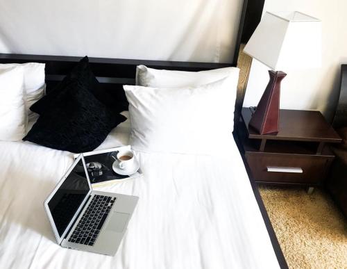 a laptop computer sitting on top of a bed at SPA Hotel in Vorzelʼ