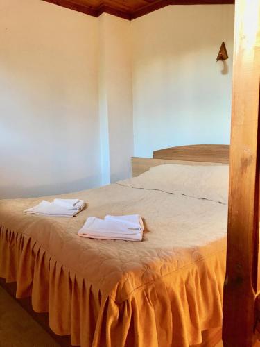 a bedroom with two beds with white towels on it at Daf Trans Hotel in Peshtera