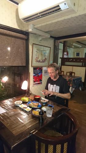 a woman standing at a table with food on it at Live Cafe Hisui no Umi in Itoigawa