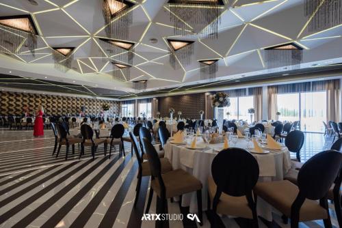 a banquet hall with long tables and chairs at Hotel Bavka in Leskovac