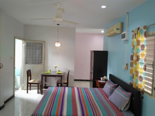a bedroom with a bed and a dining room at Studio with aircon n kitchen in Bang Tao Beach