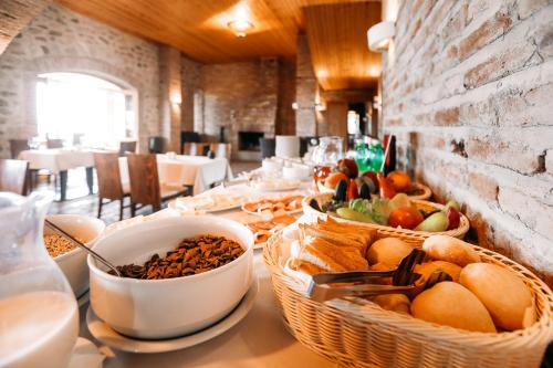 a table with baskets of fruit and other food on it at Schuchmann Wines Château,Villas & SPA in Tʼelavi