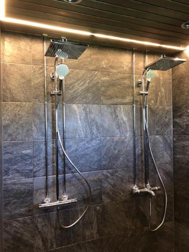 a shower in a bathroom with a glass wall at Miekojärvi Resort in Sirkkakoski