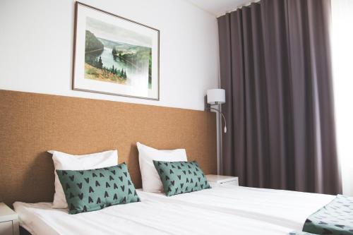 Ένα ή περισσότερα κρεβάτια σε δωμάτιο στο Hotel Aakenus