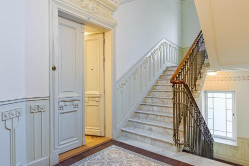 a staircase in a home with white walls and a door at Warsaw Concept in Warsaw