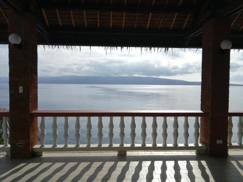 a view of the water from a balcony of a building at Wuthering Heights Bed & Breakfast by the Sea in Dumaguete