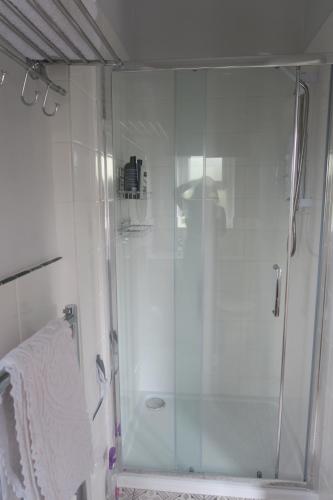 a shower with a glass door in a bathroom at Farfield in Threshfield