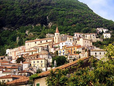 a group of buildings on a hill with a mountain at Hotel Club San Diego in Maratea