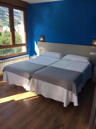 A bed or beds in a room at Narcea Turismo Real