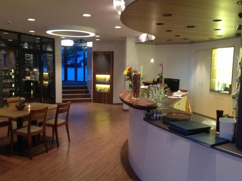 a restaurant with a bar and a table and chairs at Superior Hotel Nidwaldnerhof in Beckenried