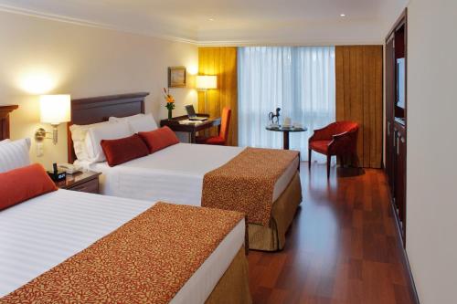 Postel nebo postele na pokoji v ubytování Hotel Estelar La Fontana