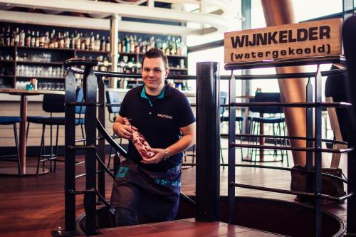 a man holding a piece of meat in his hands at Delta Hotel in Vlaardingen