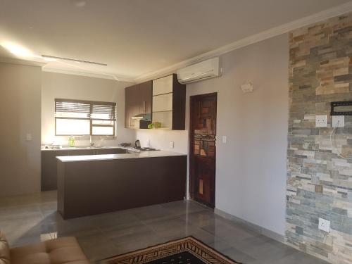 a kitchen with a sink and a counter top at Sunflower Guesthouse in Vanderbijlpark