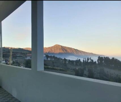a view of a mountain from a window at Bromo Otix Guest House in Bromo