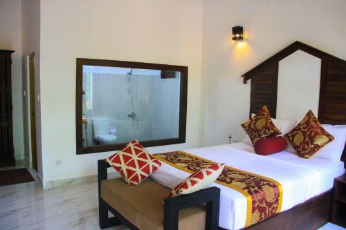 Letto o letti in una camera di Palmyra Nature Resort Sigiriya