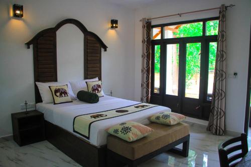 Letto o letti in una camera di Palmyra Nature Resort Sigiriya