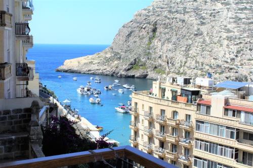 a view of a harbor with boats in the water at Serenity - Bellevue Gozo in Xlendi