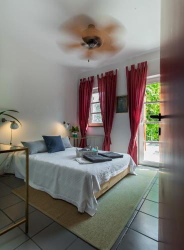 a bedroom with a bed and a ceiling fan at My Secret Garden - Swimming Pool Villa in Kriopigi