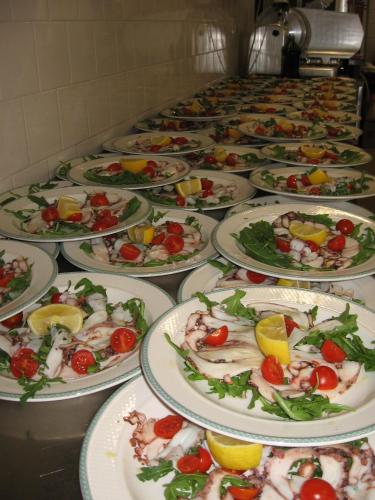 a row of plates of food on a table at Hotel Aquila D'Oro in Misano Adriatico