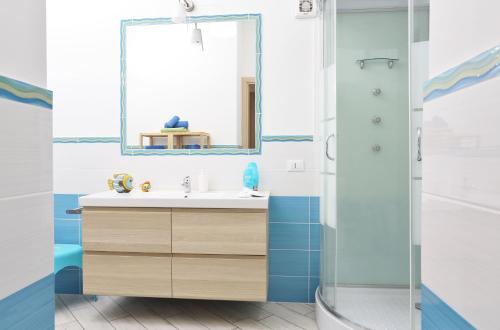 a bathroom with a sink and a shower at Capo d'Orlando Apartments in Capo dʼOrlando