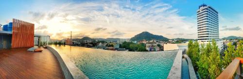 a swimming pool on top of a building at EcoLoft Hotel - SHA Plus in Phuket Town