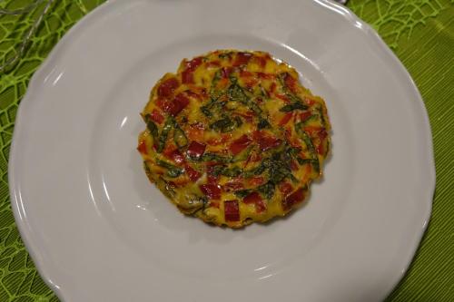 a small pizza on a white plate on a table at giardino del tempo in Merine