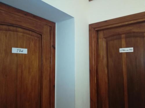 two wooden doors with signs that read tax and treason at B&B IL POETA in Palermo