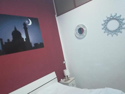 a bedroom with a bed and a mirror on the wall at B&B IL POETA in Palermo