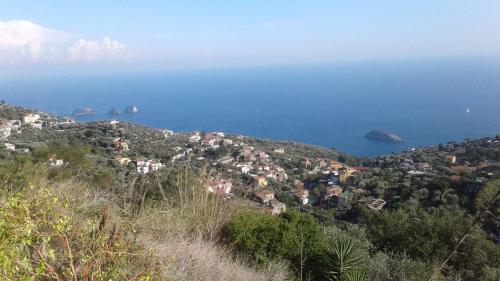a view of a town on a hill near the ocean at Madar Home in SantʼAgata sui Due Golfi
