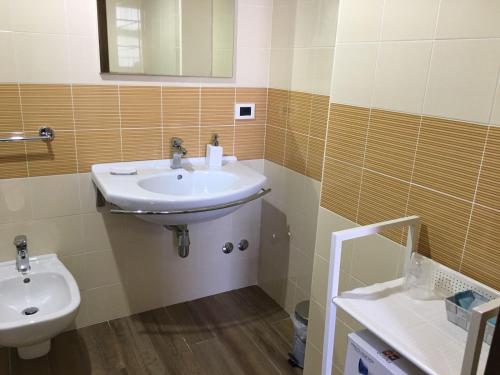 a bathroom with a sink and a toilet at 60Quattro bedrooms in Lamezia Terme
