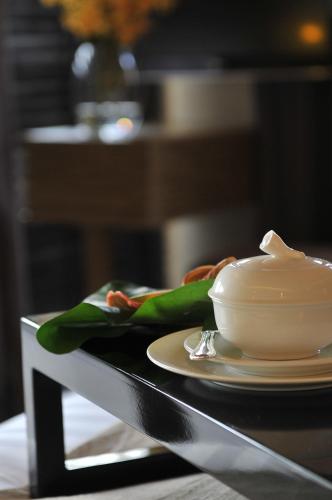 a plate of food and a bowl on a table at Ombak Villa Langkawi in Pantai Cenang