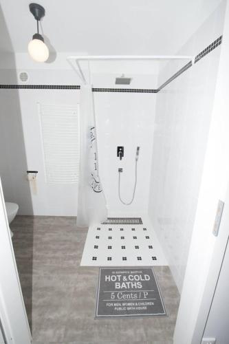 a bathroom with a toilet and a sign on the floor at Pradnik Valley Lodge in Prądnik Korzkiewski