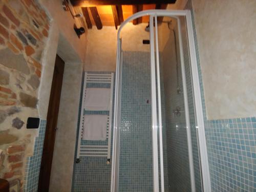 a bathroom with a shower with a glass door at Tangohotel in Lucca