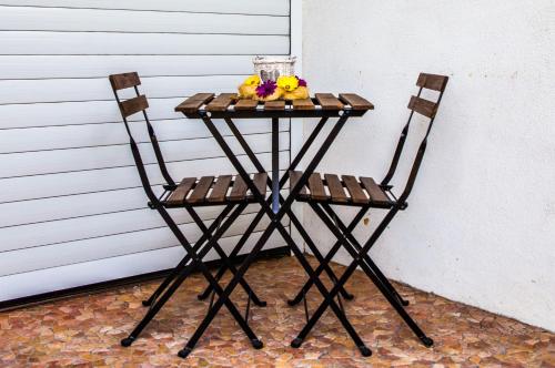 a small table with two chairs and fruit on it at Cyrus House in Dartford