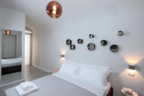 a bedroom with a white bed and a mirror at B&Bari, via Cairoli in Bari