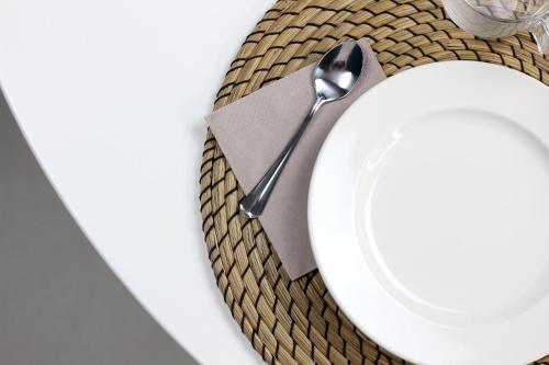 a spoon sitting on top of a white plate at B&Bari, via Cairoli - guesthouse Le Case di Aurelia in Bari