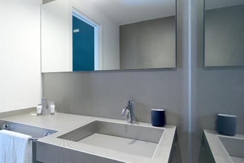 a bathroom with a sink and a mirror at B&Bari, via Cairoli - guesthouse Le Case di Aurelia in Bari