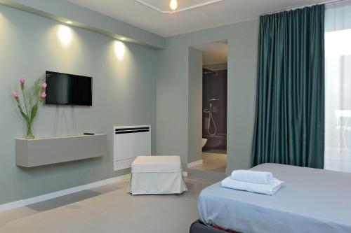 a bedroom with a bed and a tv on a wall at B&Bari, via Cairoli in Bari